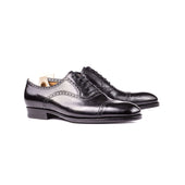 Black Oxford with brogueing on the straight toe cap, counter and top line