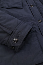 Padded field jacket crafted from a water-repellent nylon–cotton blend fabric. Blue - Navy