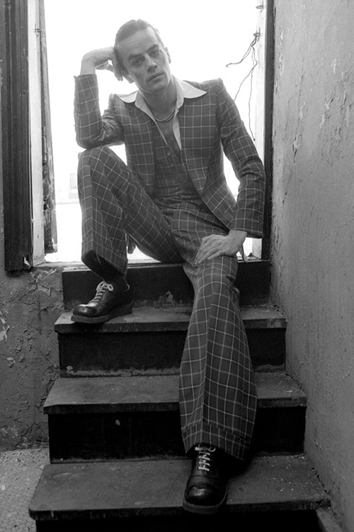 Sitting in a Checked Suit